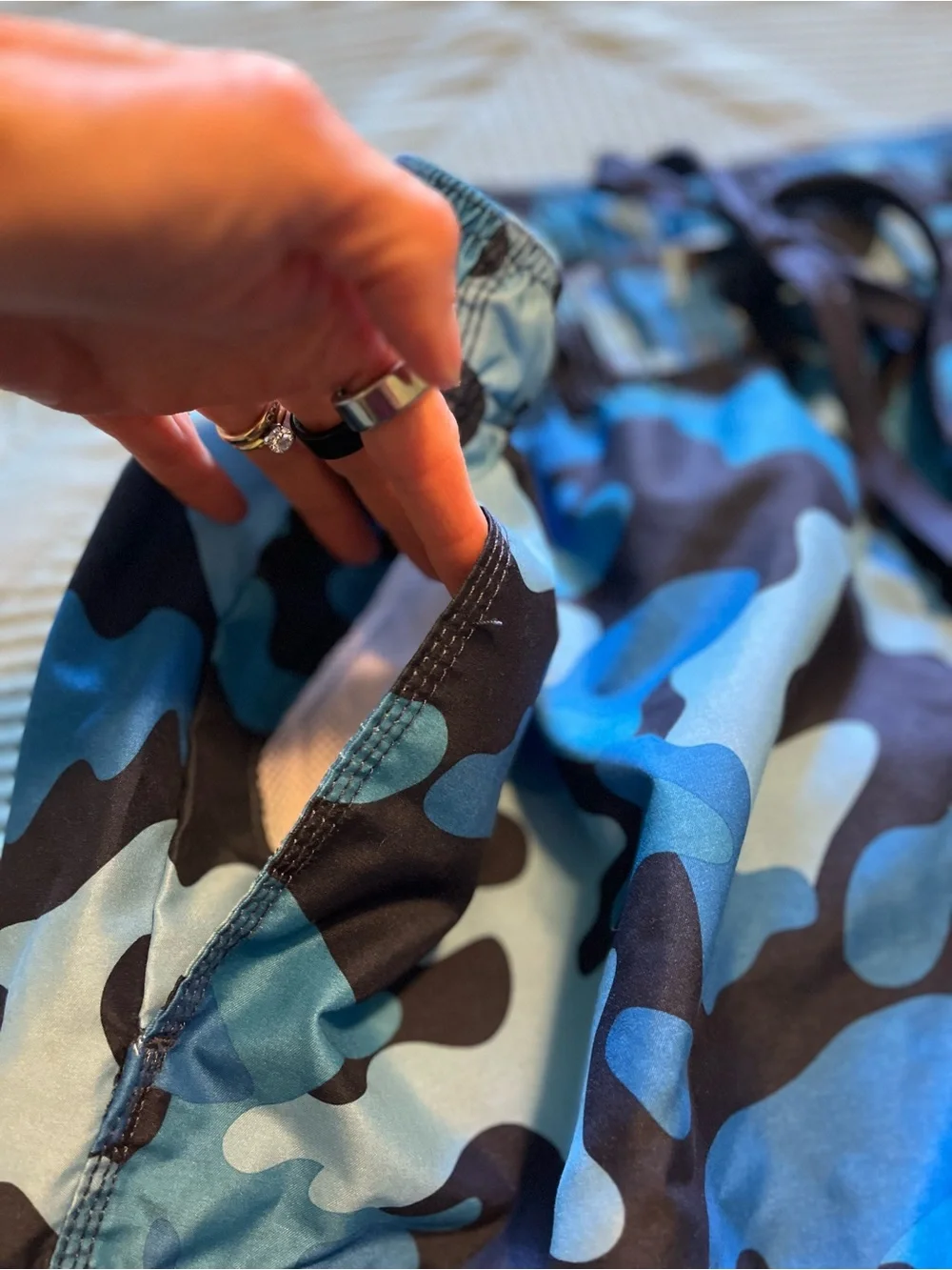 Pair of Kanu Surf Men's Blue Camo & Black Floral Swim Trunks